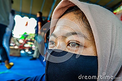 faces of young Indonesian women wearing masks to prevent the spread of covid-19 Editorial Stock Photo