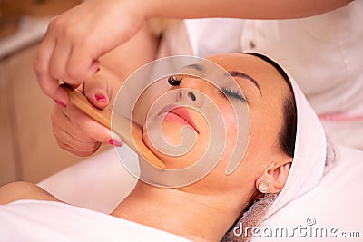 Facial madero massage with wooden tools Stock Photo