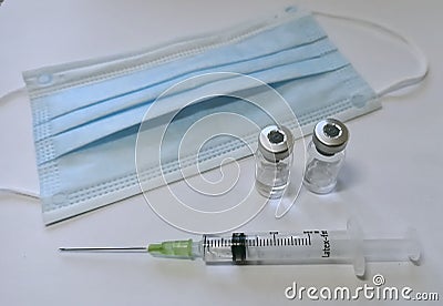 Facial Mask, Medicine, Syringe and vacine botte medical tools in time corona virus covid 19 pandemic Stock Photo