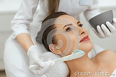 Facial Mask. Woman Applying Cosmetic Alginate Mask On Skin Stock Photo