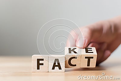 Fact or Fake concept, Hand flip wood cube change the word, April Stock Photo