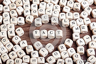 Fact word on dice letters in chaos table Stock Photo