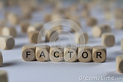 Factor - cube with letters, sign with wooden cubes Stock Photo