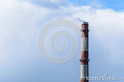 Factory Chimney of a power plant with a small stream of smoke Stock Photo