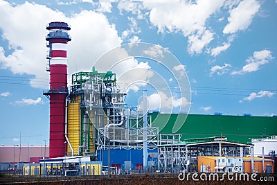 Factory with colorful tower and metallic tubes Stock Photo