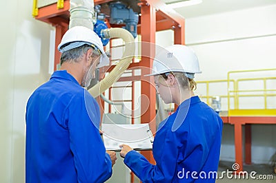 Factory engineer studying plan Stock Photo