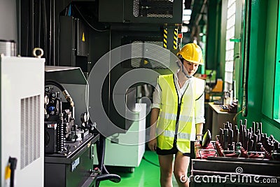 Factory female inspector check machine equipment Stock Photo