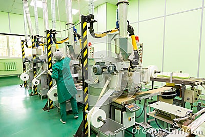Factory and industrial concept. Worker with technological equipment at factory Editorial Stock Photo