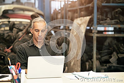 Factory industry owner manger or engineer head officer serious working at desk in warehouse workplace Stock Photo