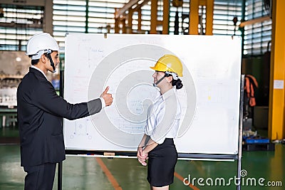 Factory manager thumps up to worker Stock Photo