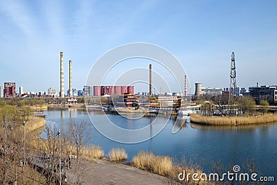 Factory site with chimney and lake Stock Photo