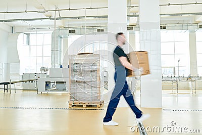 Factory Worker with Cardboard Box Stock Photo