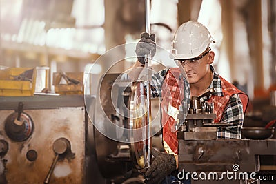 Engineer doing work with metal lathe machine carving Stock Photo