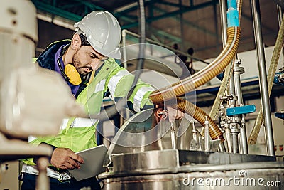 Factory worker engineer staff working in dangerous environment concept, checking chemical boiler tank Stock Photo