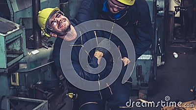 Factory worker injured by accident while using machine in factory Stock Photo