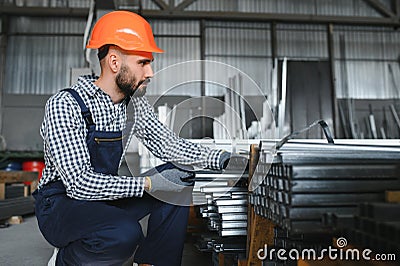 Factory worker measures the metal profile Stock Photo