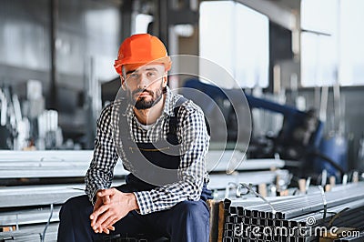 Factory worker measures the metal profile Stock Photo