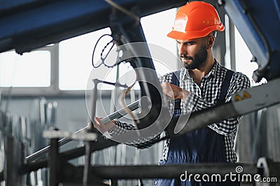 Factory worker measures the metal profile Stock Photo