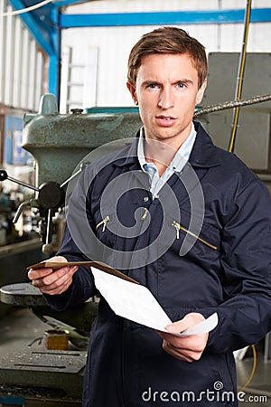 Factory Worker Reading Redundancy Letter Stock Photo