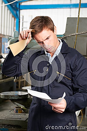 Factory Worker Reading Redundancy Letter Stock Photo