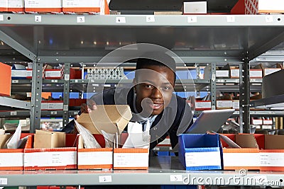 Factory Worker Using Digital Tablet In Warehouse Stock Photo