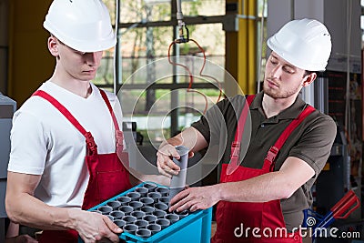 Factory workers and the box of hydraulic pipes Stock Photo