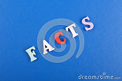 FACTS word on blue background composed from colorful abc alphabet block wooden letters, copy space for ad text. Learning Stock Photo