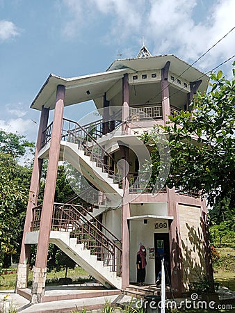 faded pink three-story cylindrical building on nature background Editorial Stock Photo