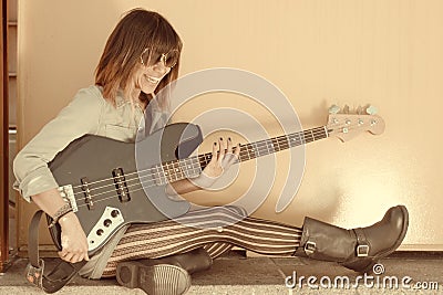 Faded portrait of laughing woman playing guitar Stock Photo