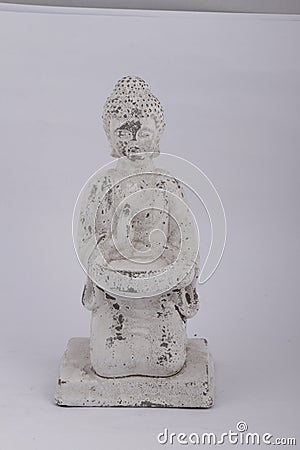 Faded white Buddha stone statue on a white background Stock Photo