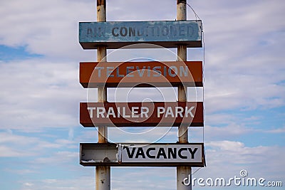 Fading, decrepit old trailer park sign for a long-gone trailer park in the California desert. Stock Photo