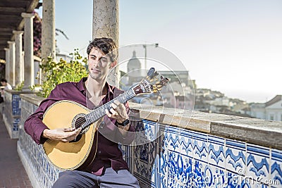 Fado musician playing on portuguese guitar in Lisbon, Portugal Stock Photo