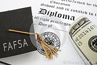 FAFSA Free Application for Federal Student Aid text on graduation cap with diploma and money Stock Photo