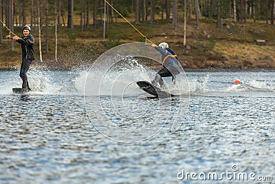 Fagersta, Sweden - Maj 01, 2020: Two teenagers wakeboarders on a lake during a physical education lesson Editorial Stock Photo