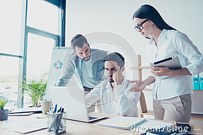 Fail, dissapointment, frustration concept. Three colleagues entrepreneurs are very upset seeing bad news Stock Photo
