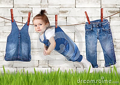 Failed housework creative concept, Funny child hanging on clothe Stock Photo