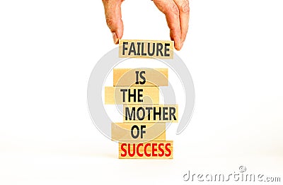 Failure or success symbol. Wooden blocks with words A failure is the mother of success. Beautiful white table white background. Stock Photo