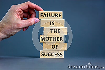 Failure or success symbol. Wooden blocks with words A failure is the mother of success. Beautiful grey table grey background. Stock Photo