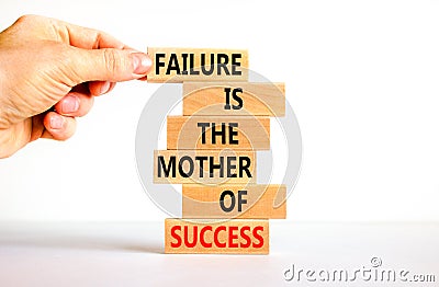 Failure or success symbol. Wooden blocks with words A failure is the mother of success. Beautiful white table white background. Stock Photo