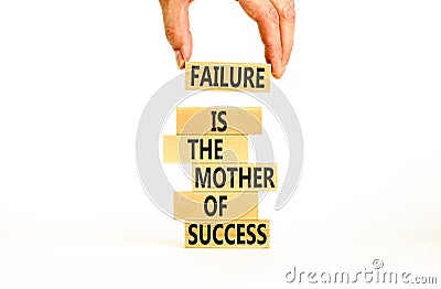 Failure or success symbol. Wooden blocks with words A failure is the mother of success. Beautiful white table white background. Stock Photo