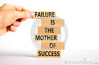 Failure or success symbol. Wooden blocks with words A failure is the mother of success. Beautiful white table white background. Stock Photo