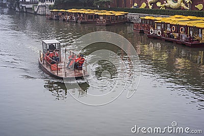 A faint foggy day, a small motor boat driving on the Qinhuai River Editorial Stock Photo