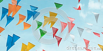 Fair flag bunting colorful background hanging on blue sky for fun fiesta party event, summer holiday farm feast celebration Stock Photo