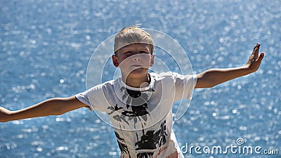 A fair-haired boy against the blue sea Stock Photo