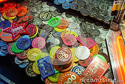 Fairground chips many colors on a gambling pushing slot machine Blur background Stock Photo