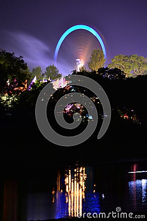 Fairground Rides and River Reflections Stock Photo