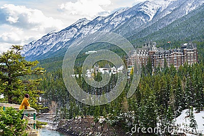 Fairmont Banff Springs and Bow River Falls in snowy autumn sunny day. Banff National Park, Canadian Rockies. Editorial Stock Photo