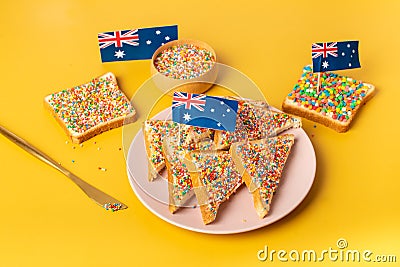 Fairy bread with butter knife, side view. The famous traditional Australian food Fairy Bread on a yellow background Stock Photo