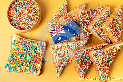 Fairy bread with butter knife, side view. The famous traditional Australian food Fairy Bread on a yellow background Stock Photo