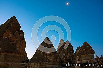 Fairy Chimneys. Peri bacalari or fairy chimneys at sunrise with moon on the sky Stock Photo